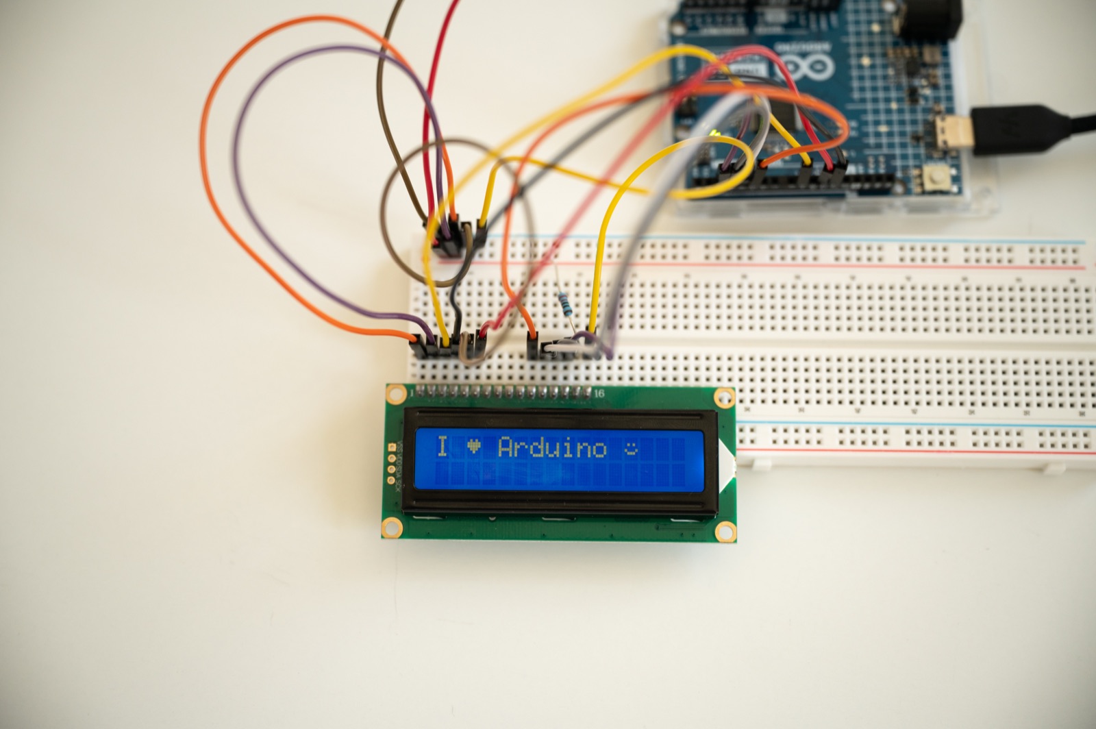 Close-up of the LCD1602 display showing 'I heart Arduino'